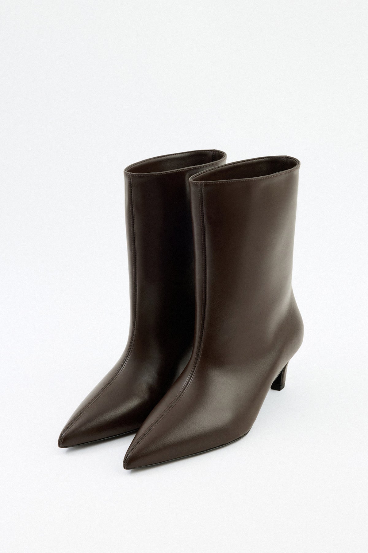 Mescini dark brown pointed toe ankle boots, angled pair view on a pale floor, US sizes