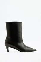 Mescini black pointed toe ankle boots, full side view on a studio backdrop, US sizes