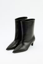Mescini black pointed toe ankle boots, angled pair view on a pale floor, US sizes