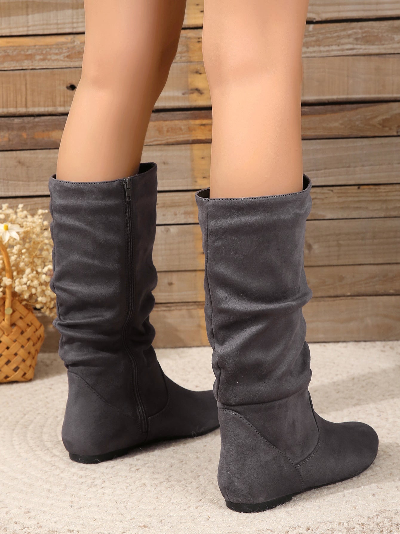 Mescini gray pleated slouch flat mid calf boots, worn from behind, model standing, US women's sizes