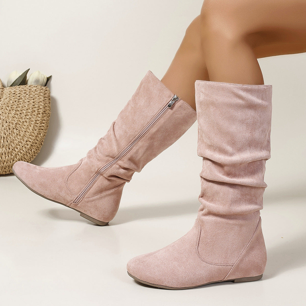 Mescini pink pleated slouch flat mid calf boots, worn by a seated model, side zip open, US women's sizes
