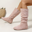 Mescini pink pleated slouch flat mid calf boots, worn by a seated model, side zip open, US women's sizes