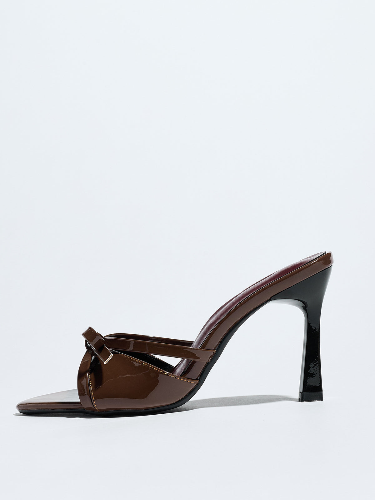Mescini brown bow pointed toe stiletto mules, one shoe seen from the side, US women's sizes
