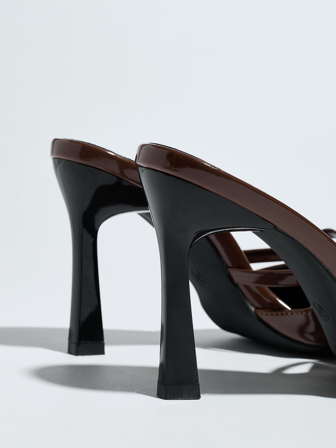 Mescini brown bow pointed toe stiletto mules, rear view of the two heels, US women's sizes