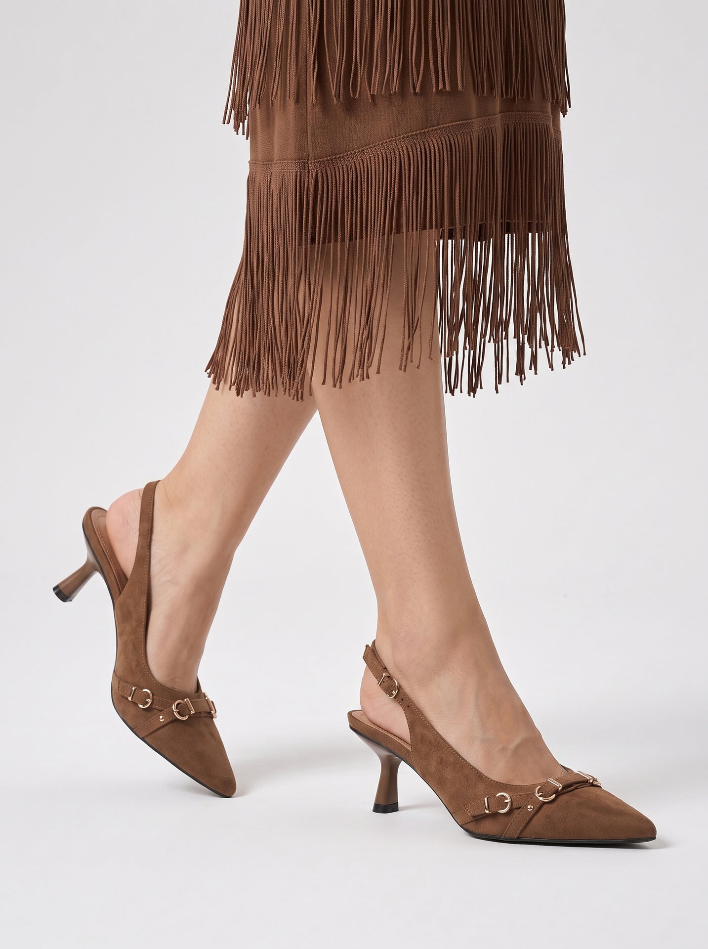 Mescini brown buckle strap pointed slingback heels, worn mid stride, side view, US women's sizes