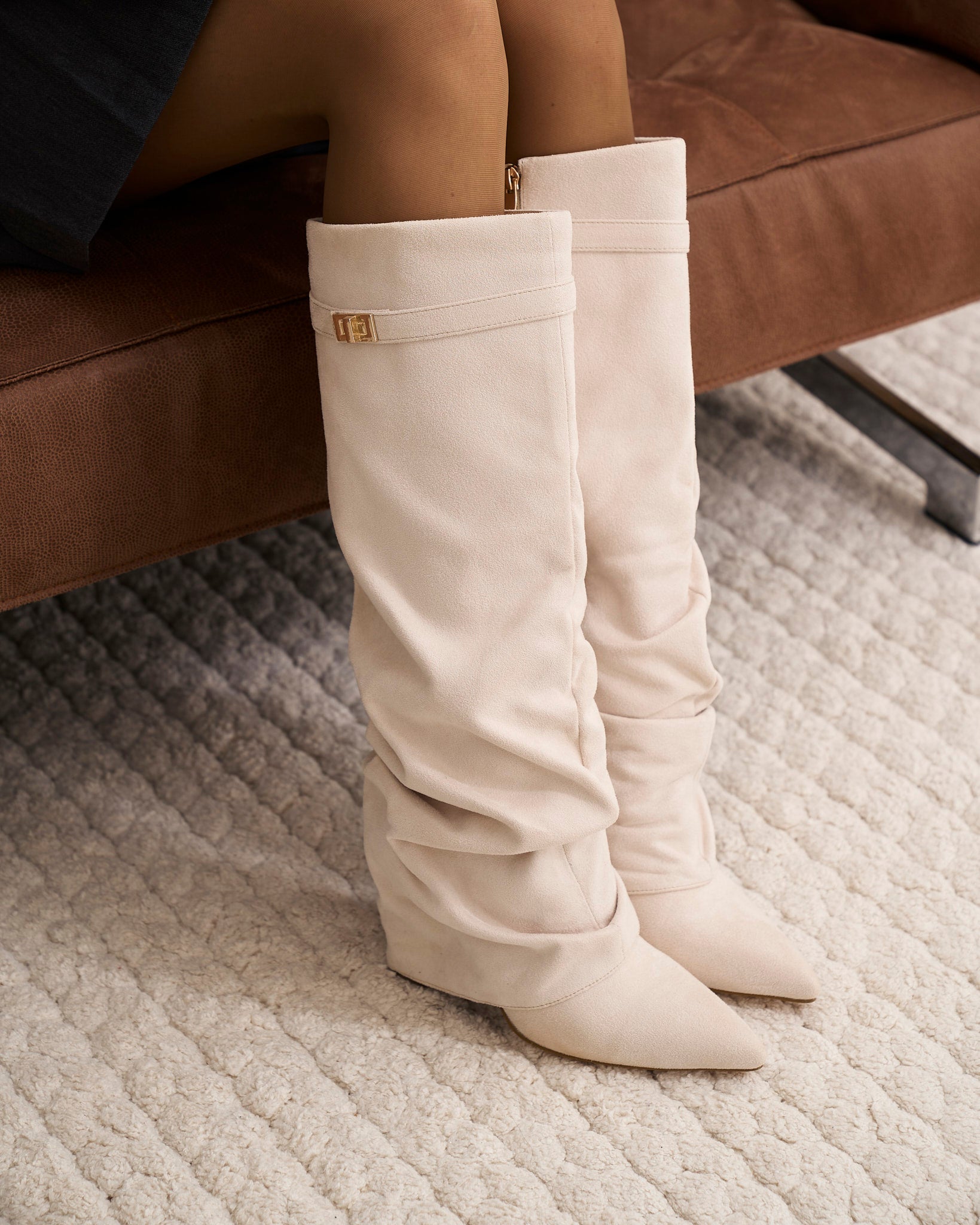 Mescini cream slouchy knee high boots, angled pair view on a pale floor, US sizes