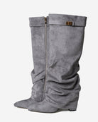 Mescini grey slouchy knee high boots, worn by a model seated on a bench, US sizes