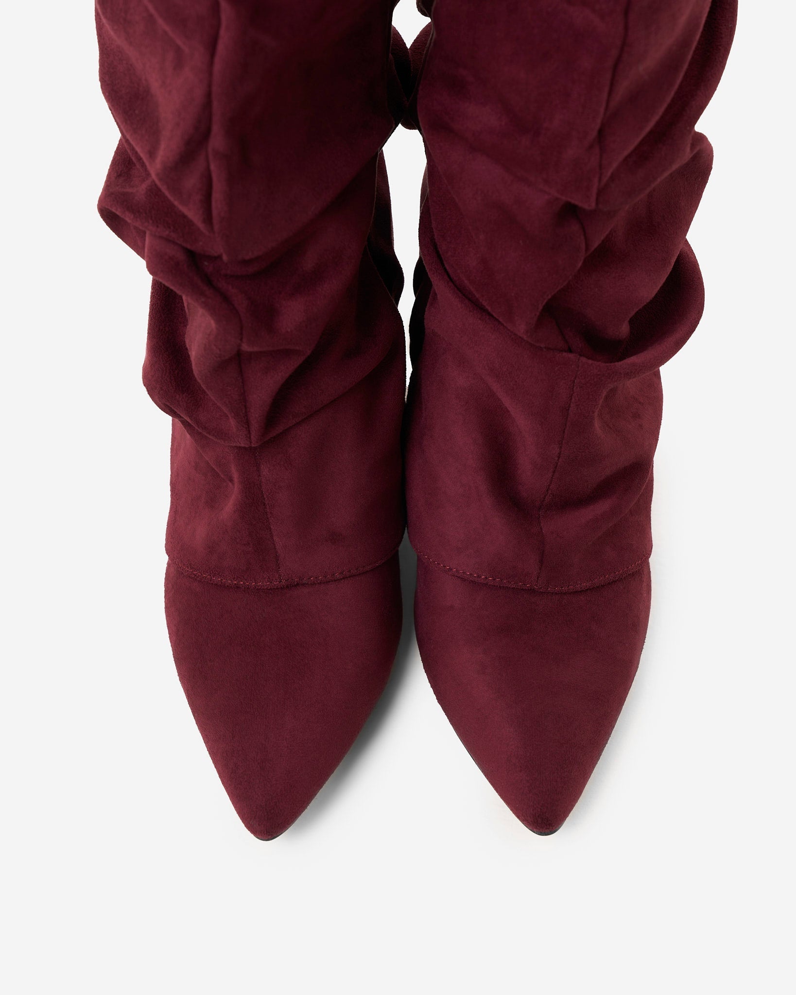 Mescini burgundy slouchy knee high boots, worn by a model seated on a bench, US sizes