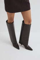Mescini dark brown fold over knee high boots, worn on the leg under a short skirt, US sizes