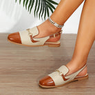 Mescini brown cap toe slingback flat sandals, worn on both feet on a wooden floor, US women's sizes