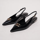 Mescini black pointed toe buckle slingback flats, pair on a white surface seen from behind, US women's sizes