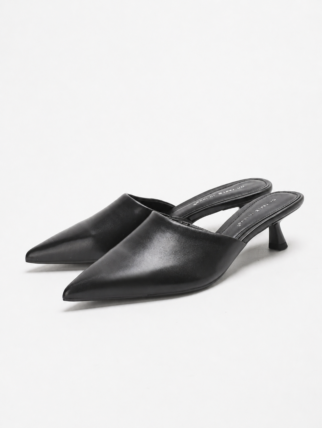 Mescini black pointed toe kitten heel mules, angled pair on a white ground, US women's sizes