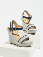 Mescini navy blue canvas platform wedge sandals, one shoe posed on a white riser, US women's sizes