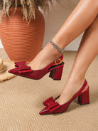 Mescini wine red croc print bow slingback block heels worn beside a clay pot, US women's sizes