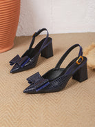 Mescini blue croc print bow slingback block heels, pair placed on a woven rug, US women's sizes