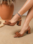 Mescini caramel croc print bow slingback block heels worn standing on a rug, US women's sizes