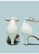 Mescini white embroidered floral ankle strap pumps, back view of the slim heels, US women's sizes