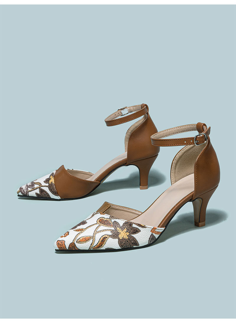 Mescini brown embroidered floral ankle strap pumps, pair angled on pale blue, US women's sizes