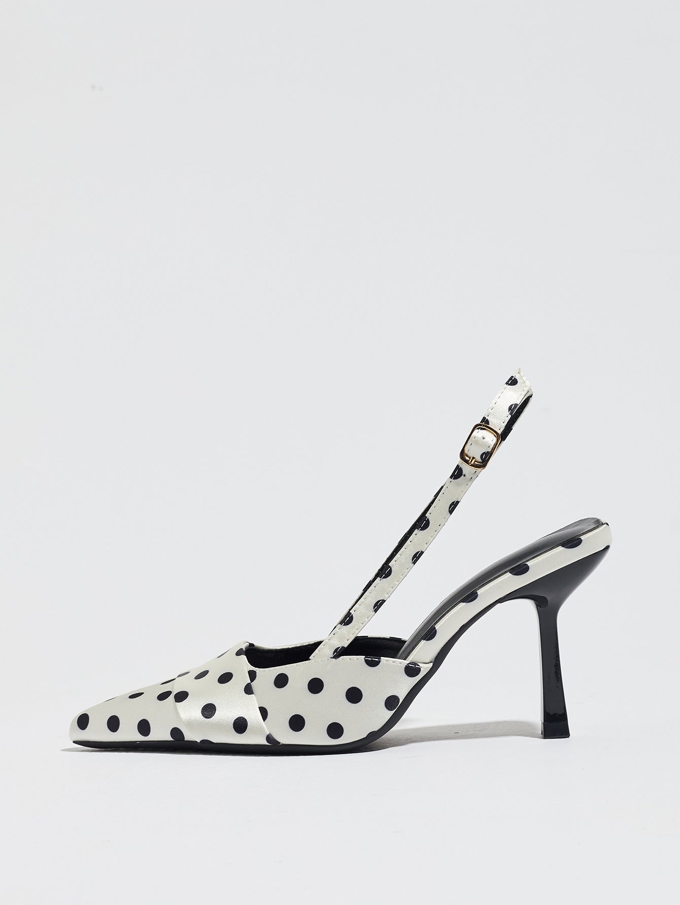 Mescini white polka dot slingback stiletto heels, single shoe seen from the side, US women's sizes