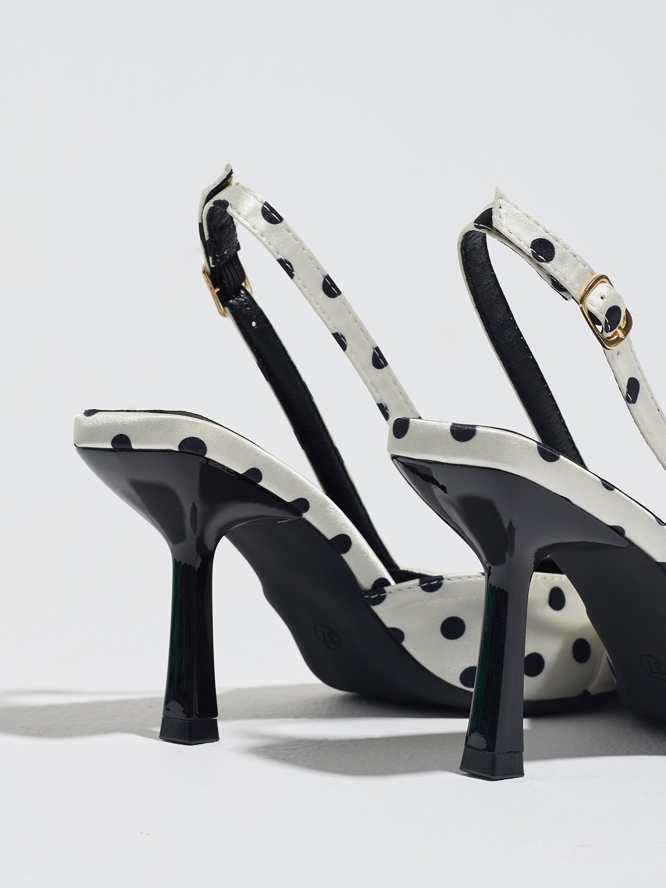 Mescini white polka dot slingback stiletto heels, rear view of the ankle strap and buckle, US women's sizes