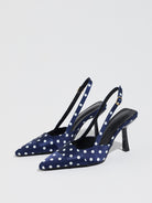 Mescini navy polka dot slingback stiletto heels, pair angled on a pale studio floor, US women's sizes