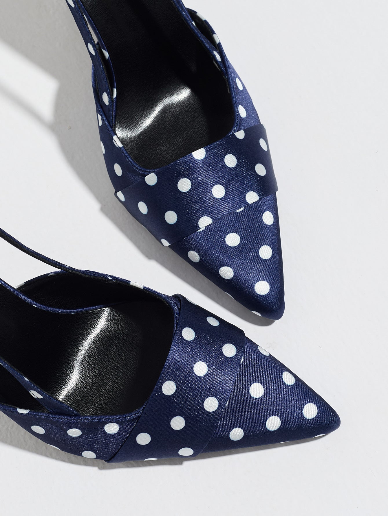 Mescini navy polka dot slingback stiletto heels, close up of the satin pointed toes, US women's sizes