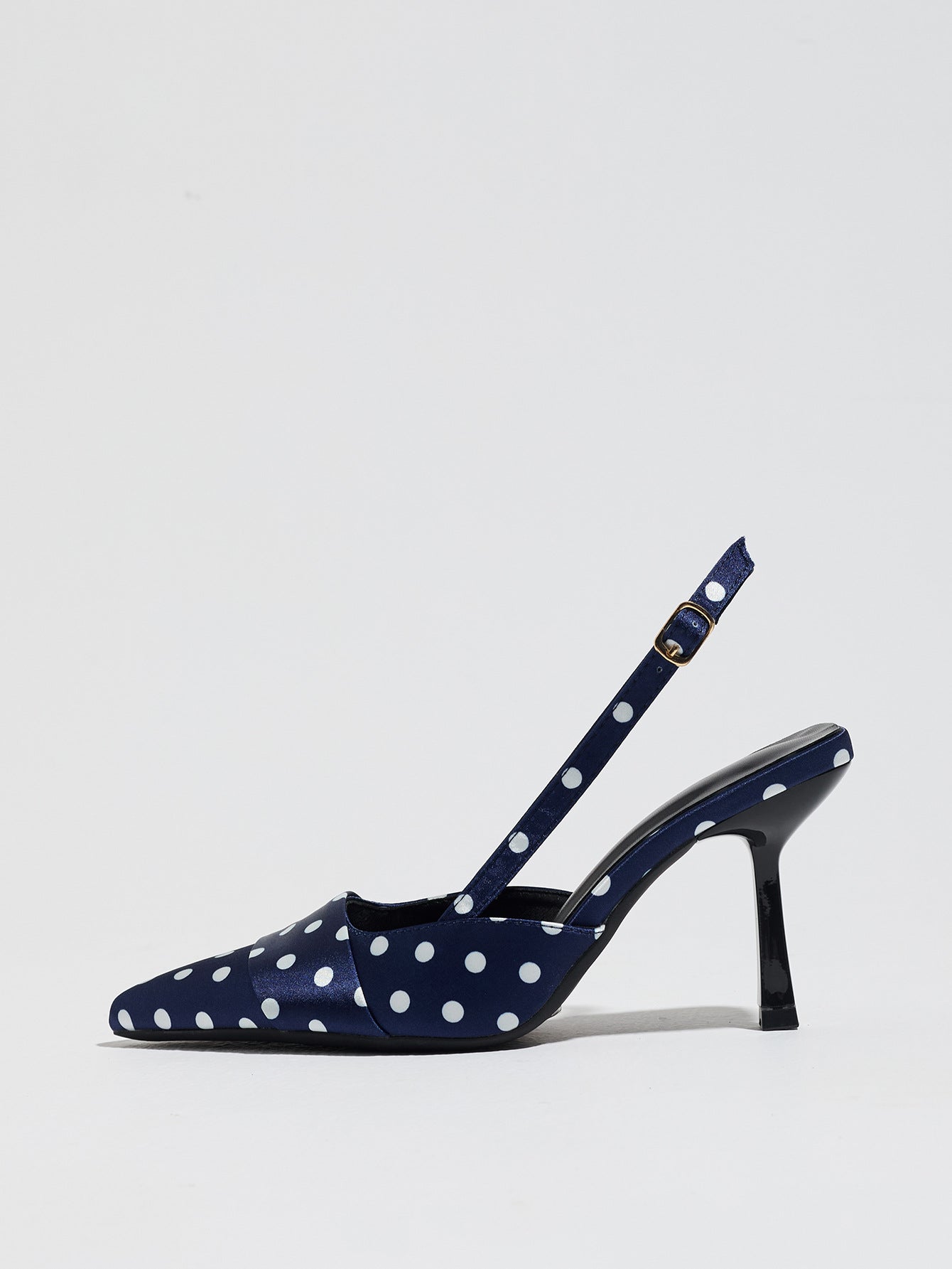 Mescini navy polka dot slingback stiletto heels, single shoe photographed from the side, US women's sizes