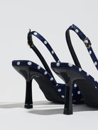 Mescini navy polka dot slingback stiletto heels, rear view showing the buckle strap, US women's sizes