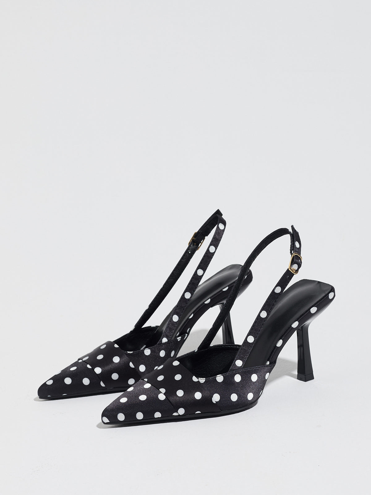 Mescini black polka dot slingback stiletto heels, pair angled with the straps upright, US women's sizes