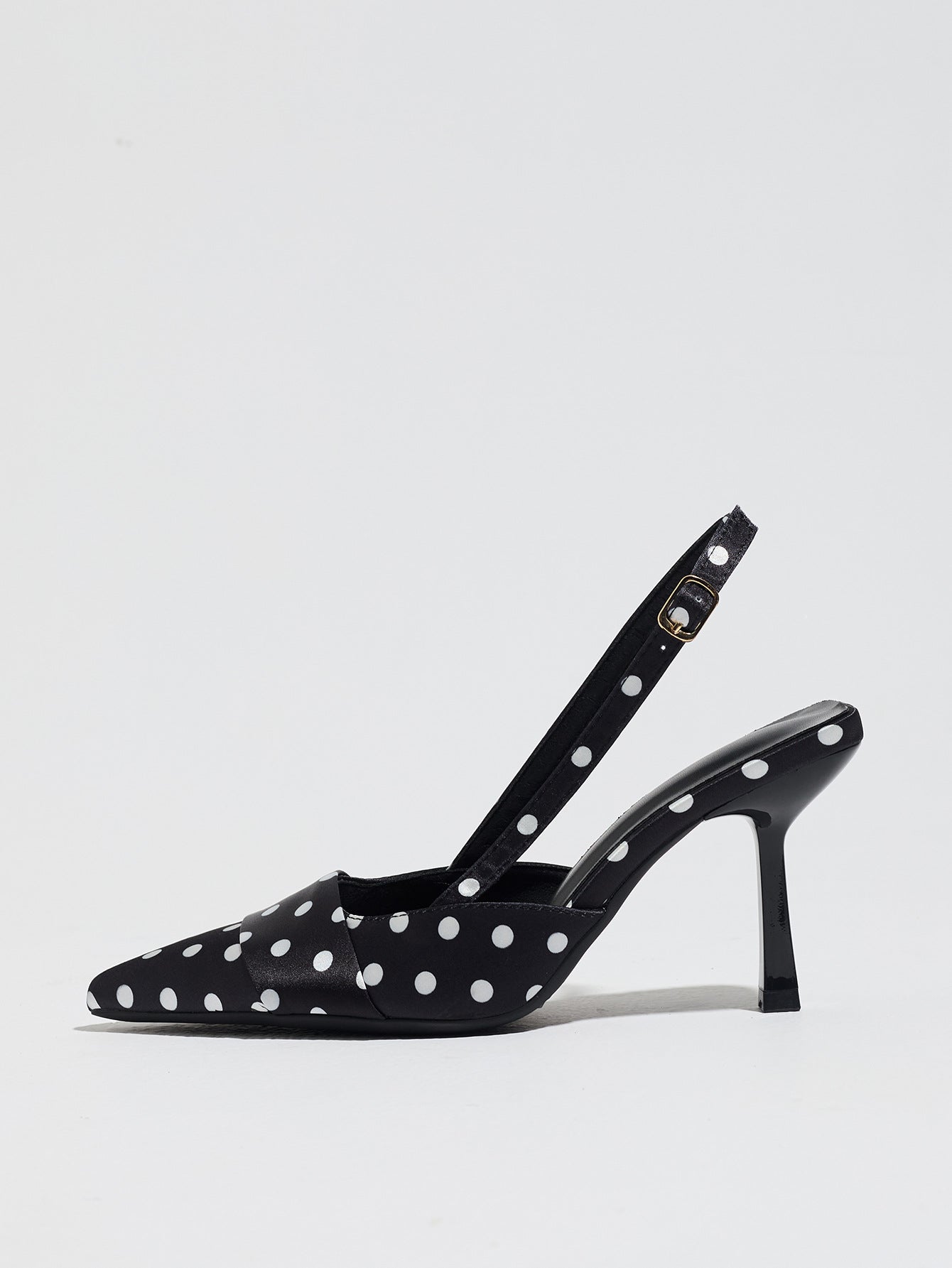 Mescini black polka dot slingback stiletto heels, single shoe in profile on white, US women's sizes