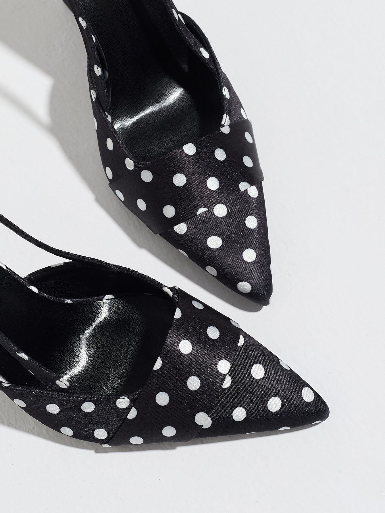 Mescini black polka dot slingback stiletto heels, close up of the pointed toe and vamp, US women's sizes