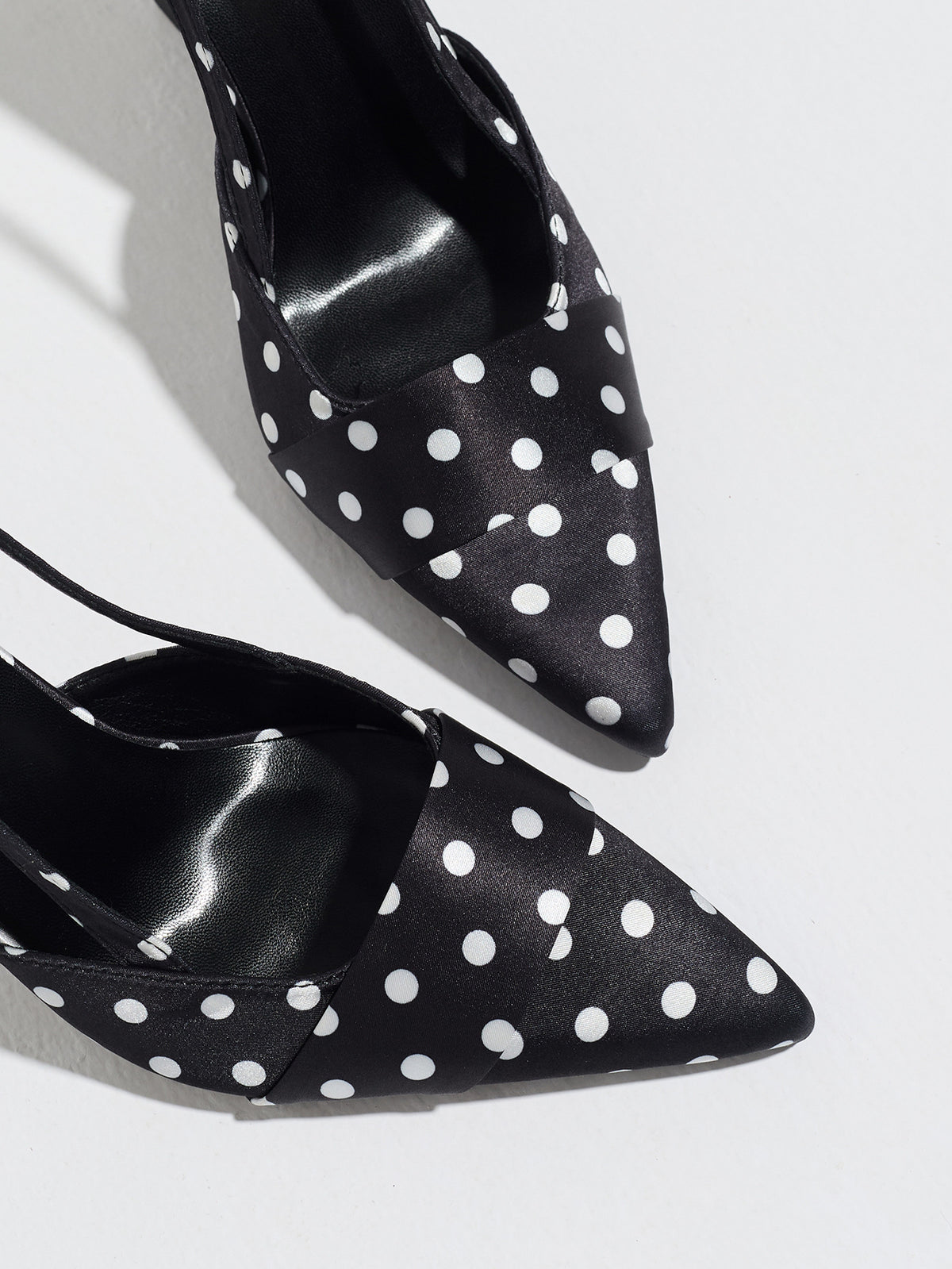 Mescini black polka dot slingback stiletto heels, close up of the pointed toe and vamp, US women's sizes