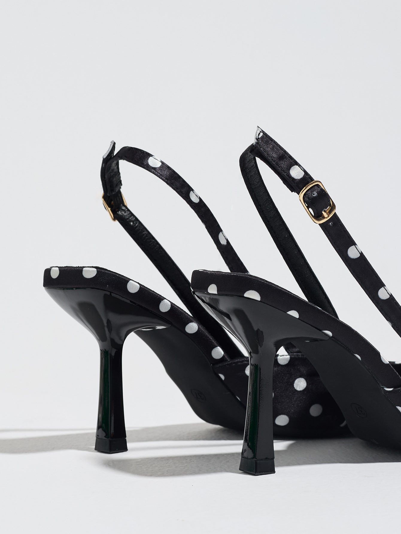 Mescini black polka dot slingback stiletto heels, rear view of the buckle and back strap, US women's sizes
