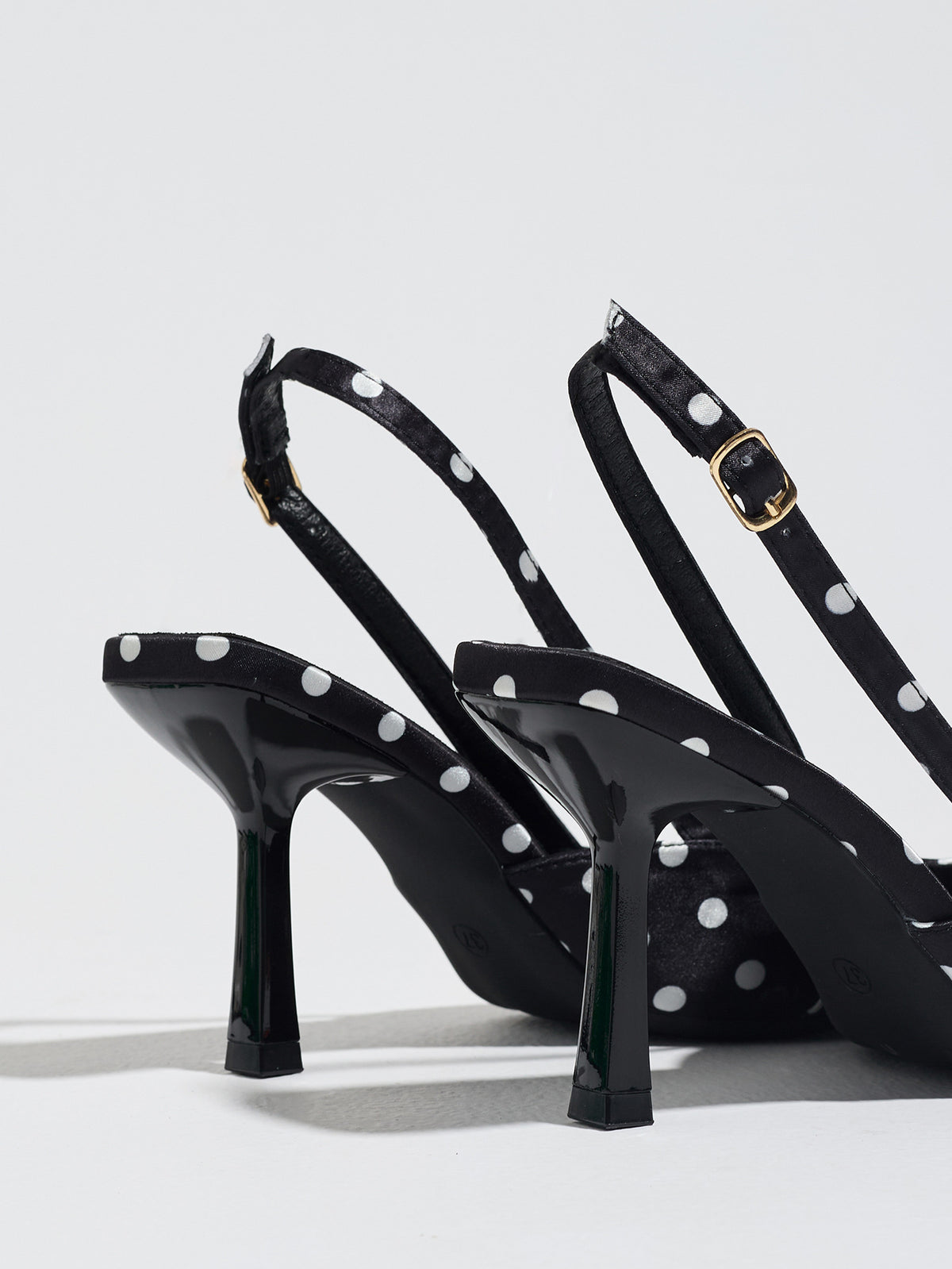 Mescini black polka dot slingback stiletto heels, rear view of the buckle and back strap, US women's sizes