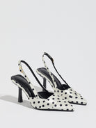 Mescini white polka dot slingback stiletto heels, pair angled on a light grey floor, US women's sizes