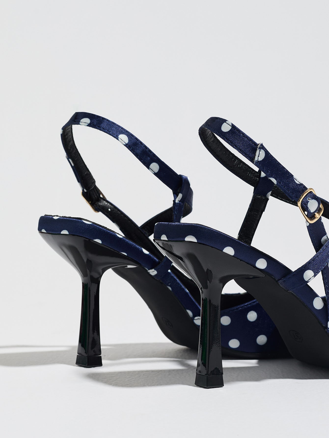 Mescini navy polka dot slingback heels, rear view of the standing pair, US women's sizes