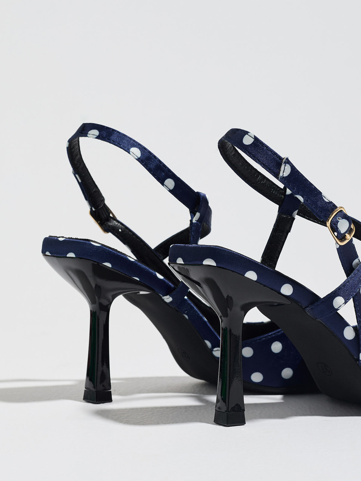 Mescini navy polka dot slingback heels, rear view of the standing pair, US women's sizes