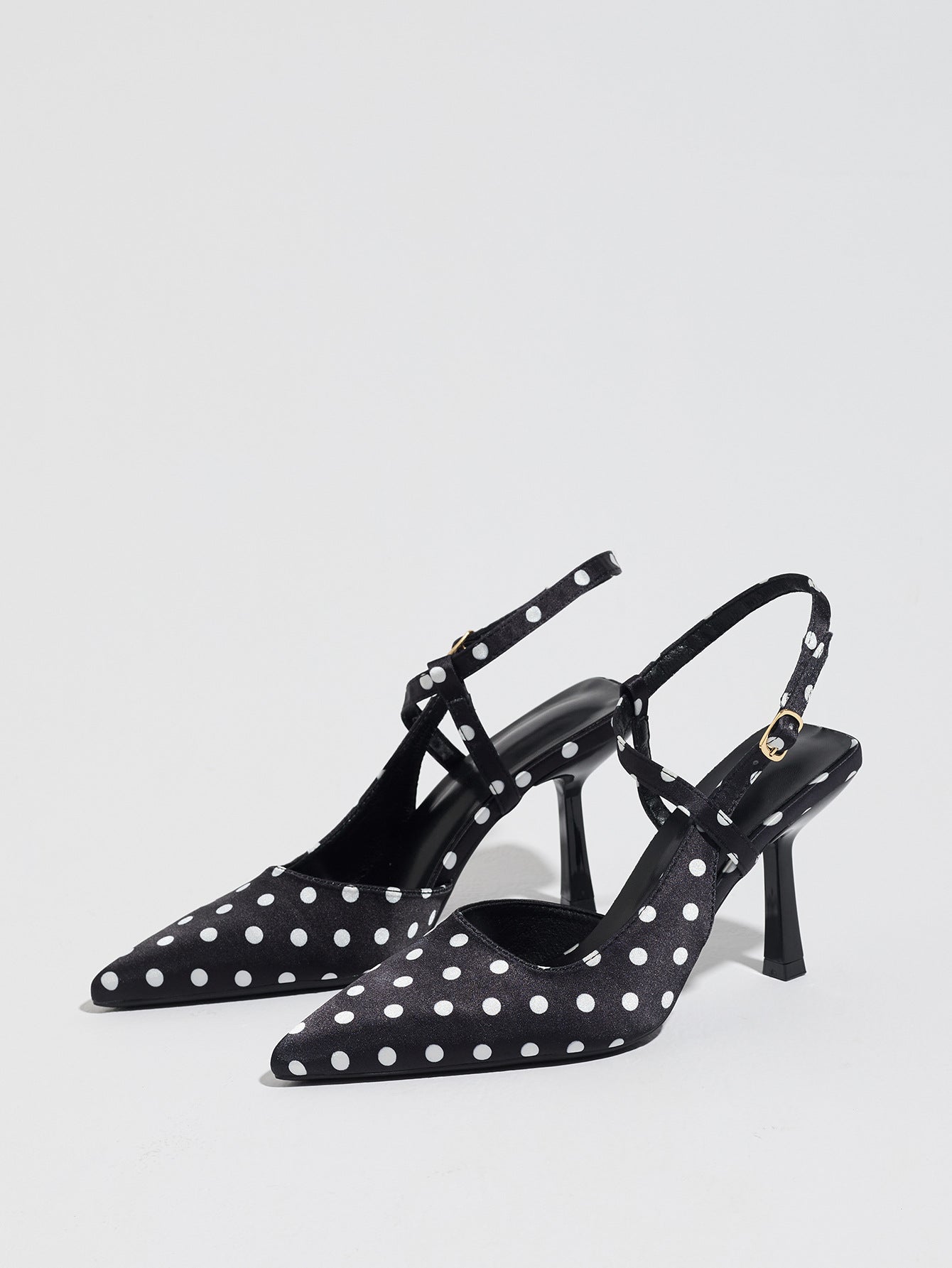 Mescini black polka dot pointed toe slingback heels, angled pair on white, US women's sizes