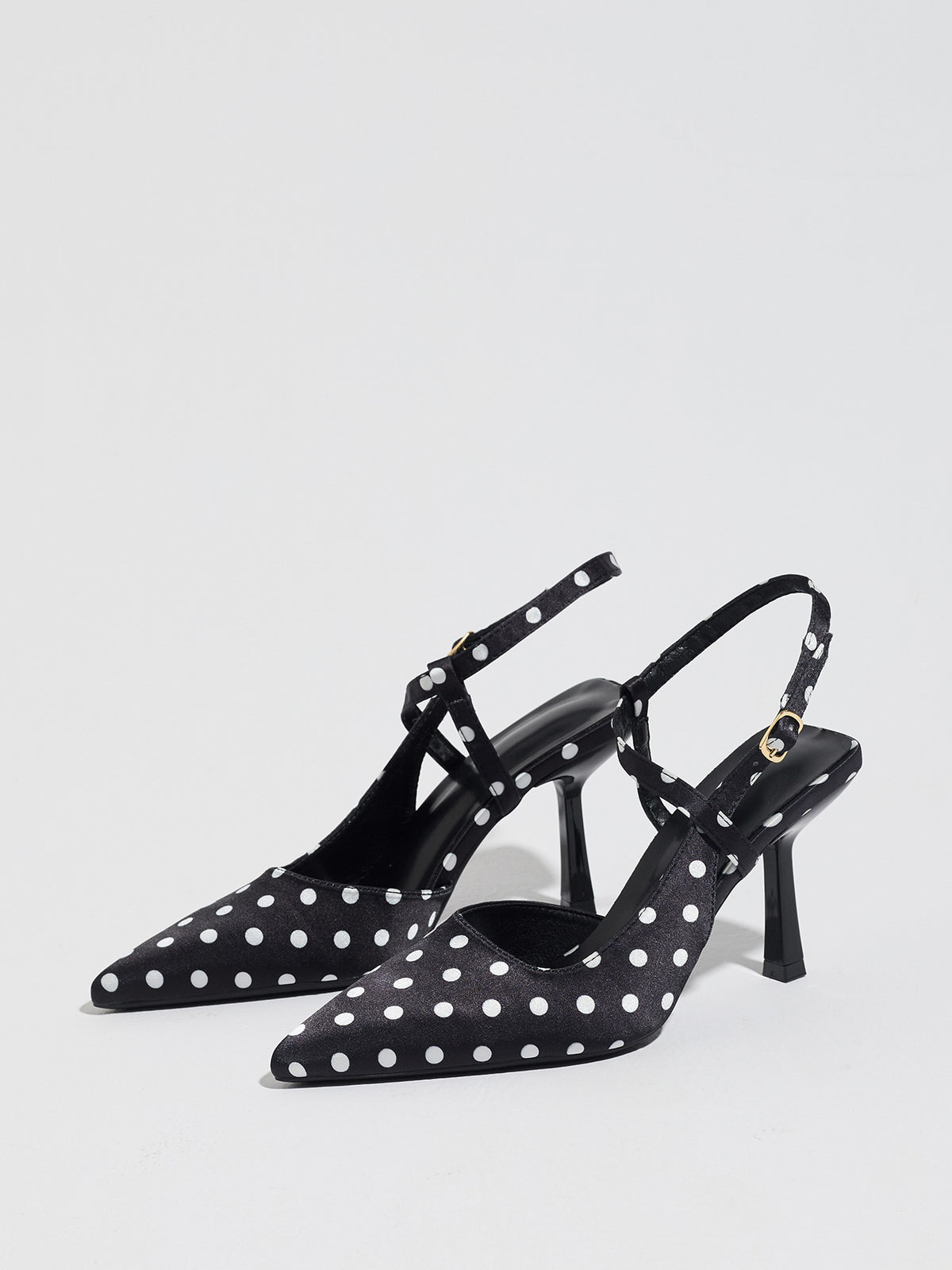 Mescini black polka dot pointed toe slingback heels, angled pair on white, US women's sizes