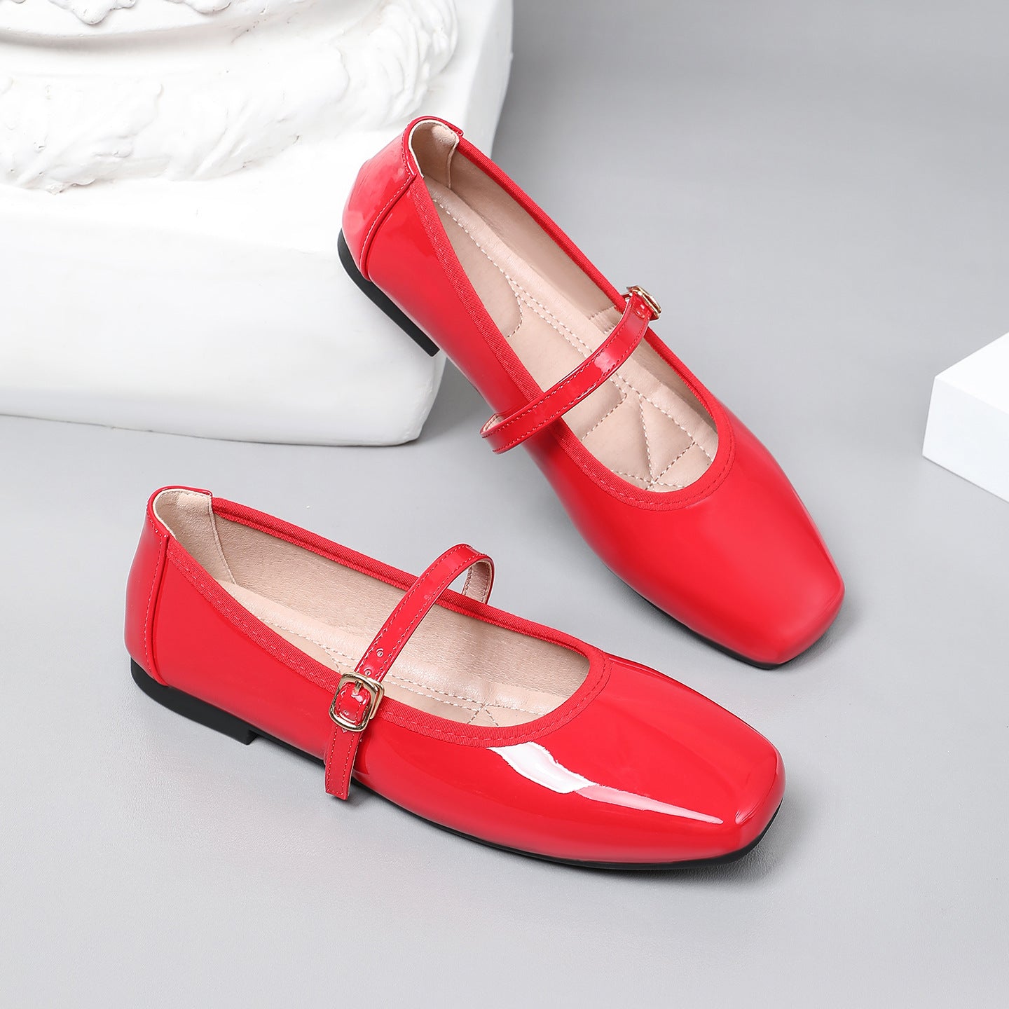 Mescini red patent square toe mary jane flats, pair angled in front of a white block, US women's sizes