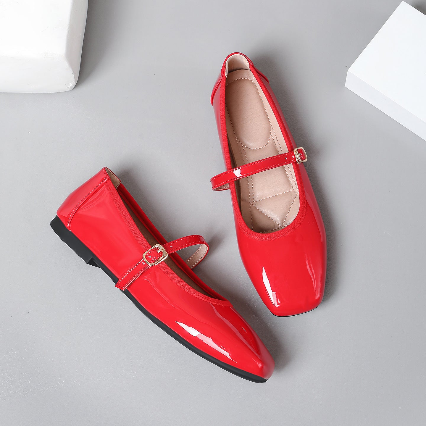 Mescini red patent square toe mary jane flats, pair with one shoe tipped on its side, US women's sizes