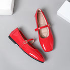 Mescini red patent square toe mary jane flats, pair with one shoe tipped on its side, US women's sizes