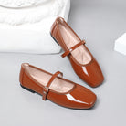 Mescini brown patent square toe mary jane flats, pair leaning against a white block, US women's sizes