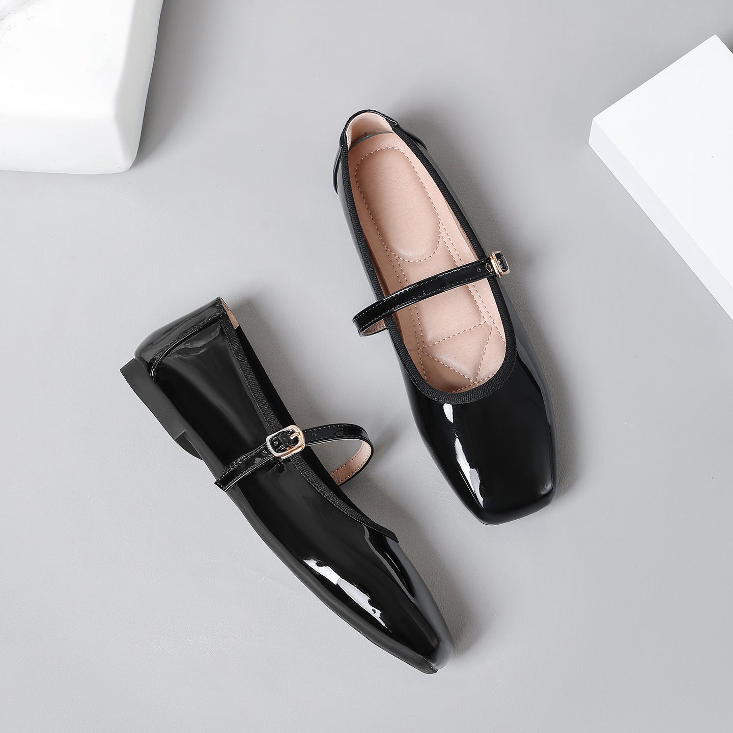 Mescini black patent square toe mary jane flats, pair on grey with one shoe on its side, US women's sizes
