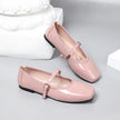 Mescini pink patent square toe mary jane flats, pair resting on a white plaster block, US women's sizes