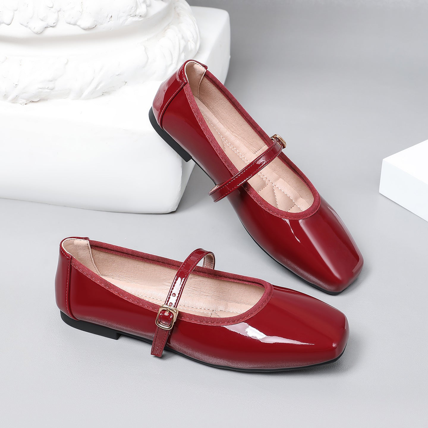 Mescini wine red patent square toe mary jane flats, pair propped on a white block, US women's sizes