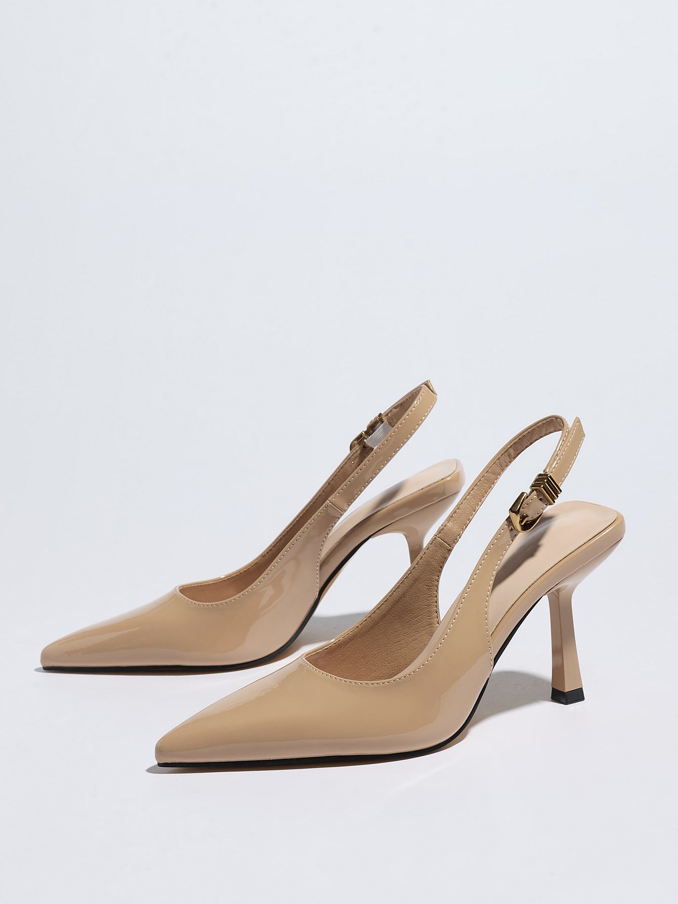 Mescini – Nude patent slingback pumps, angled studio pair on white, US women's sizes
