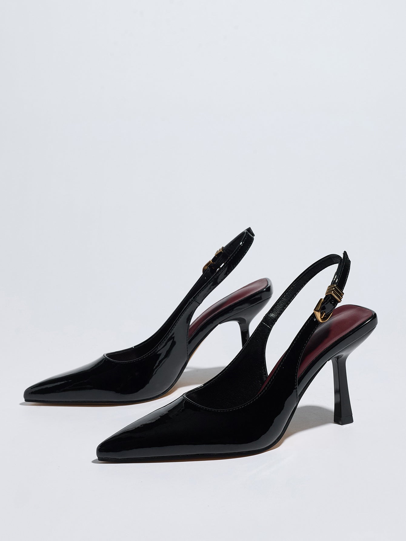 Mescini – Black patent slingback pumps, angled studio pair with red lining, US women's sizes
