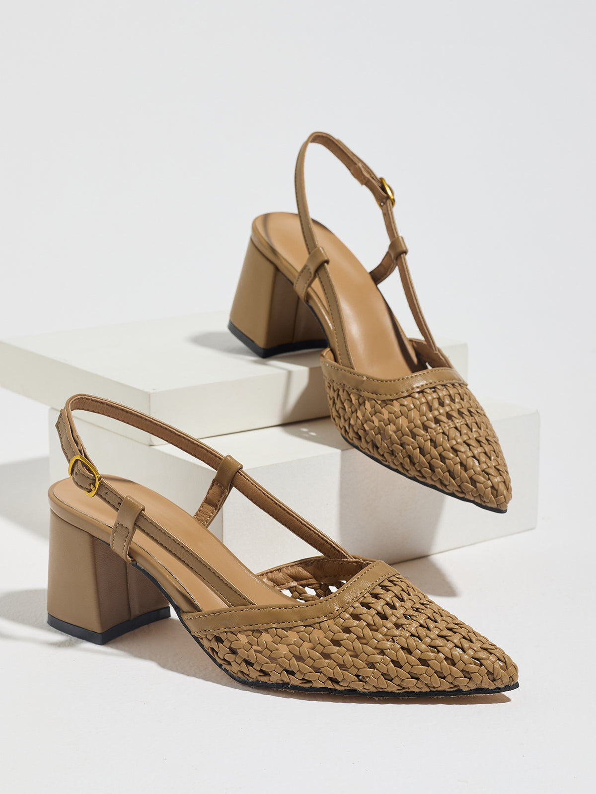Mescini brown woven pointed toe block heel pumps, pair on white display risers, US women's sizes