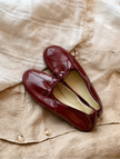 Mescini burgundy soft drawstring bow ballet flats, pair laid on linen, seen from above, US women's sizes